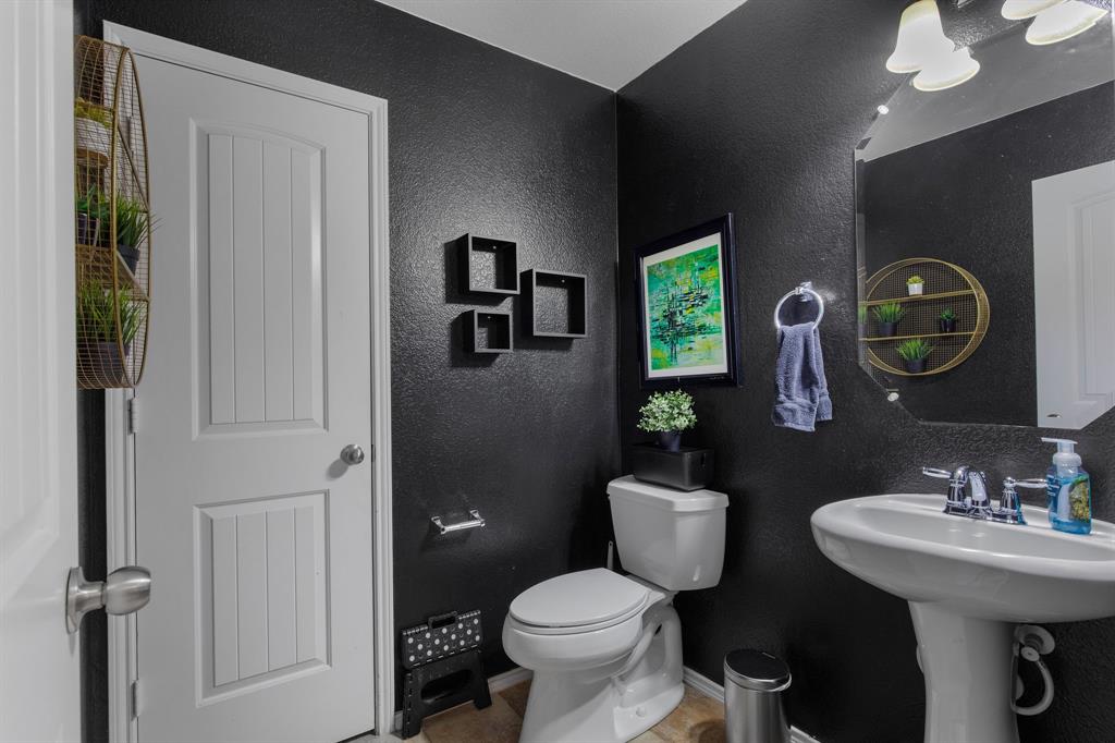 3213 Evening Wind Road Denton, TX 76208 - Photo 6 of 28 a bathroom with a toilet a sink and mirror