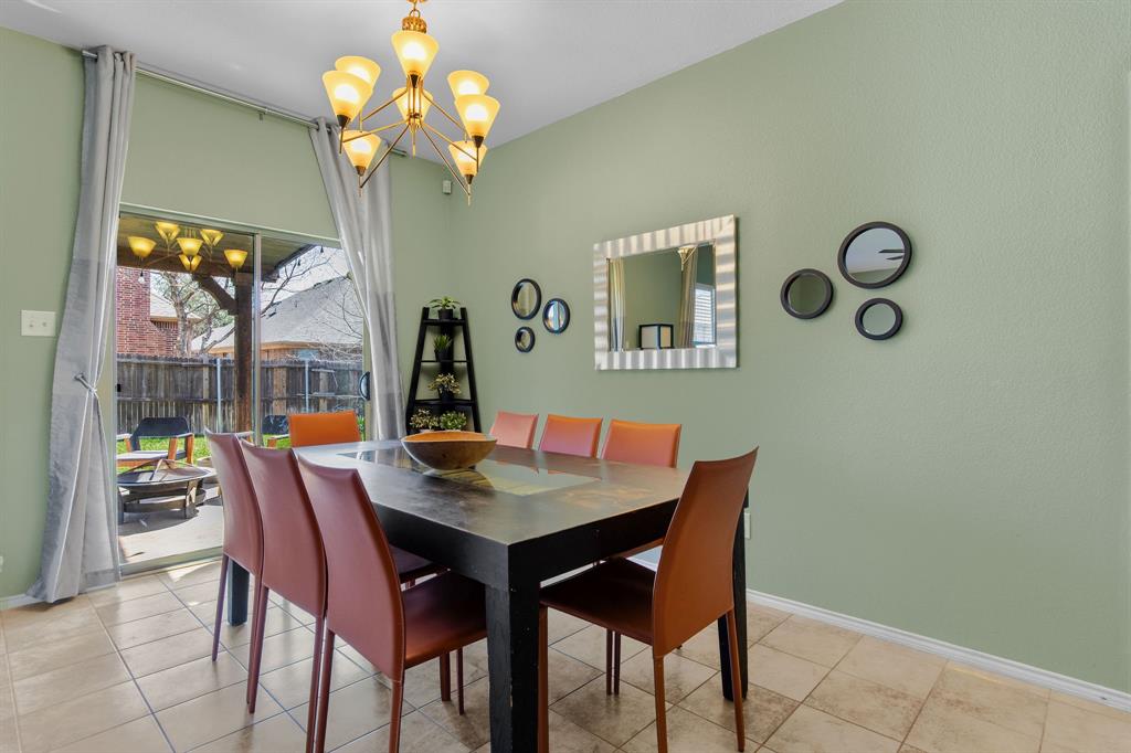 3213 Evening Wind Road Denton, TX 76208 - Photo 7 of 28 a dining room with a wooden table and chairs
