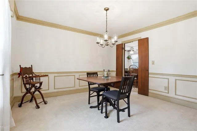 a view of a dining room with furniture and chandelier