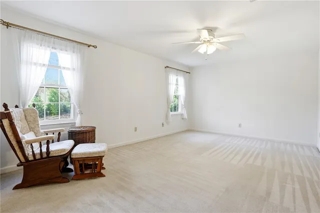 a view of a livingroom with furniture and a window
