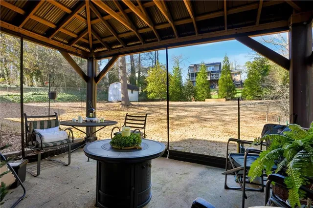 a view of a patio with chairs and a table