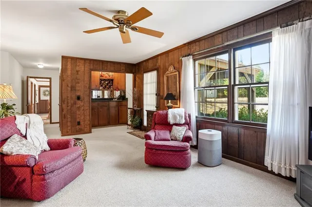 a spacious bedroom with furniture and a large window