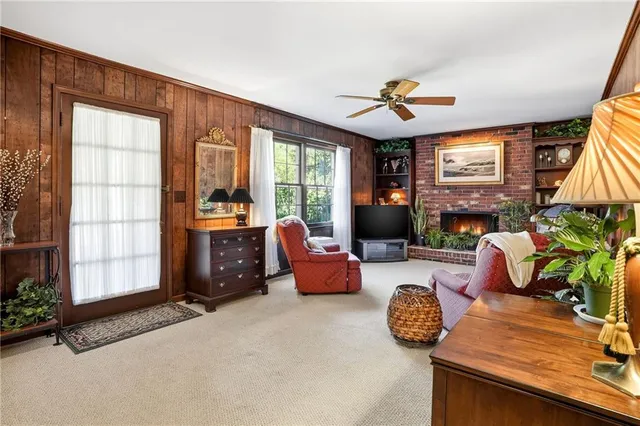 a living room with furniture fireplace and flat screen tv