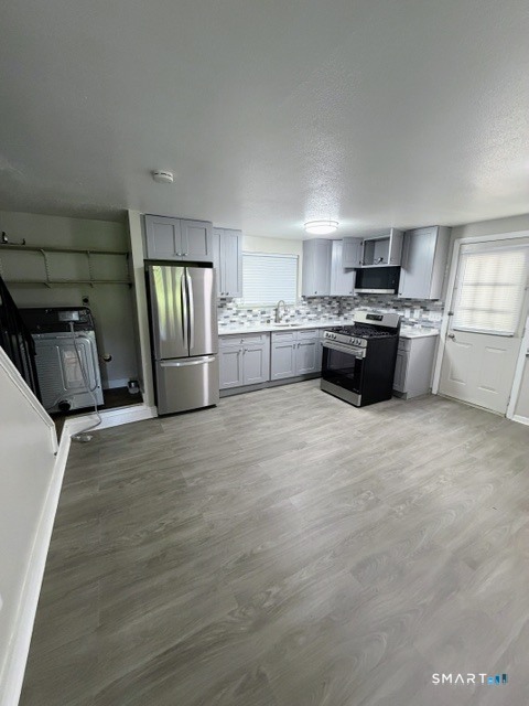 351 Mill Rock Road, Unit 351 Hamden, CT 06517 - Photo 4 of 20 a large white kitchen with a refrigerator a stove a sink and a dishwasher