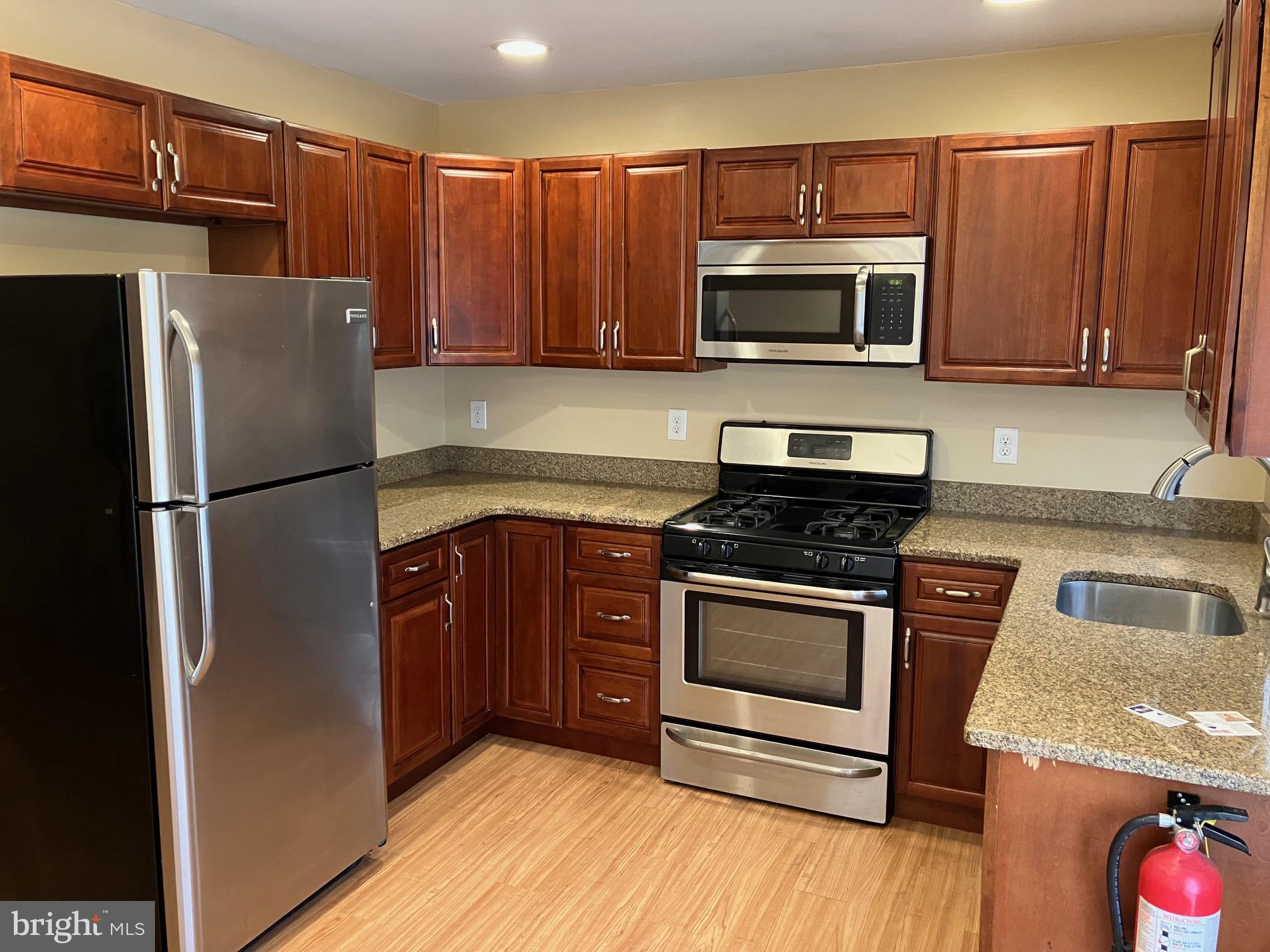 15 Blueberry Lane Willingboro, NJ 08046 - Photo 4 of 14 a kitchen with granite countertop a refrigerator stove and microwave