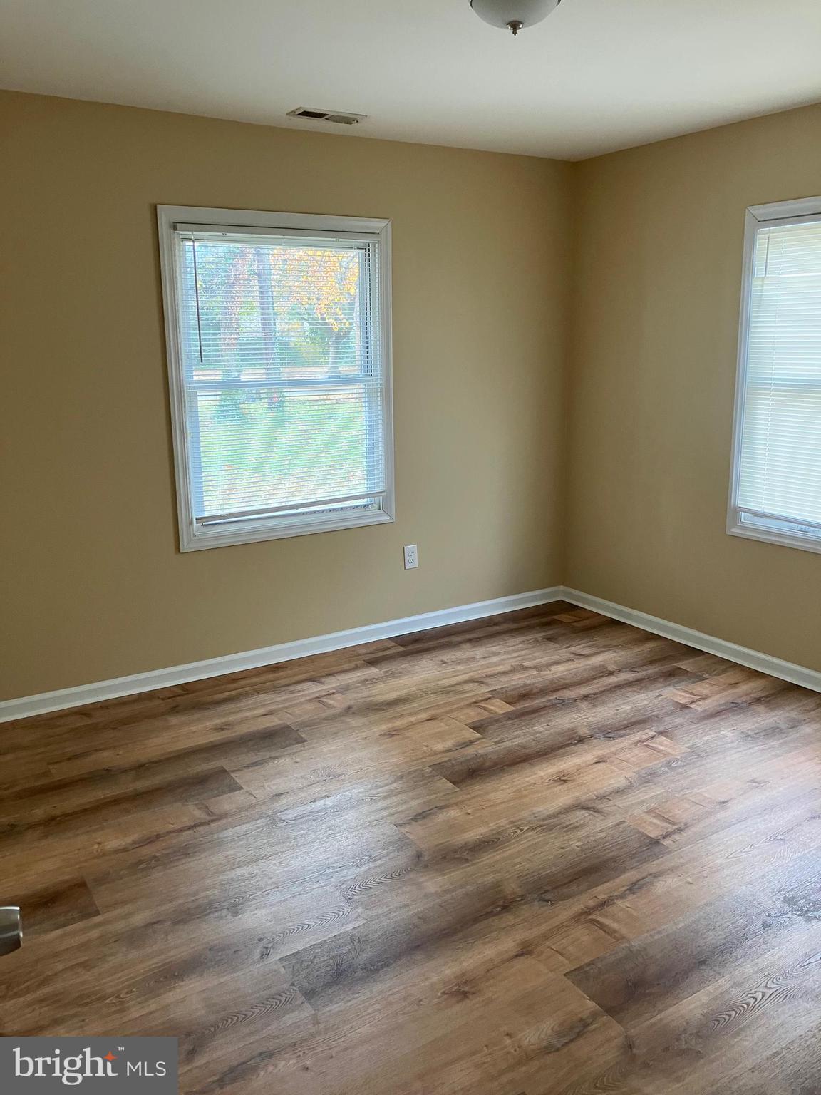 15 Blueberry Lane Willingboro, NJ 08046 - Photo 7 of 14 a view of an empty room with wooden floor and a window