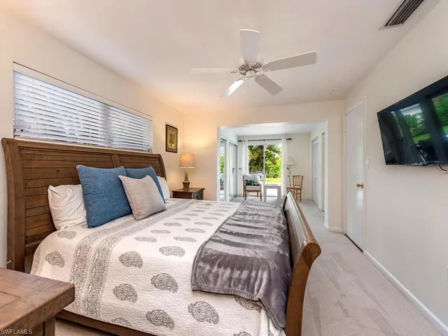 a bedroom with a large bed and a flat screen tv