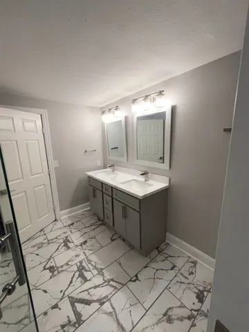 a bathroom with a sink and mirror