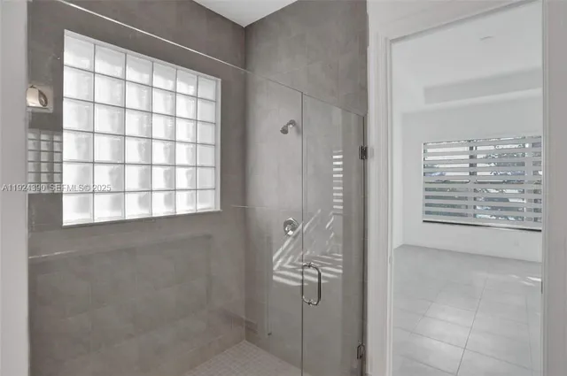 a bathroom with a bathtub and shower