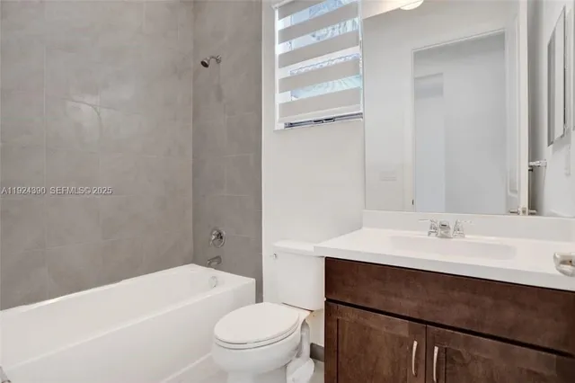 a bathroom with a sink a toilet and a bathtub