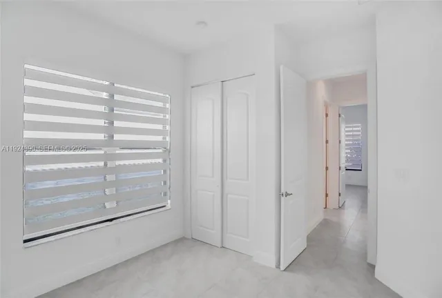 a view of room with hallway and closet
