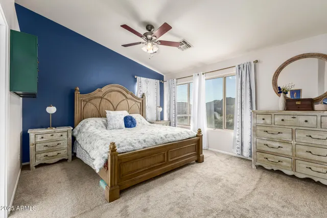 a bedroom with a bed dresser and a window