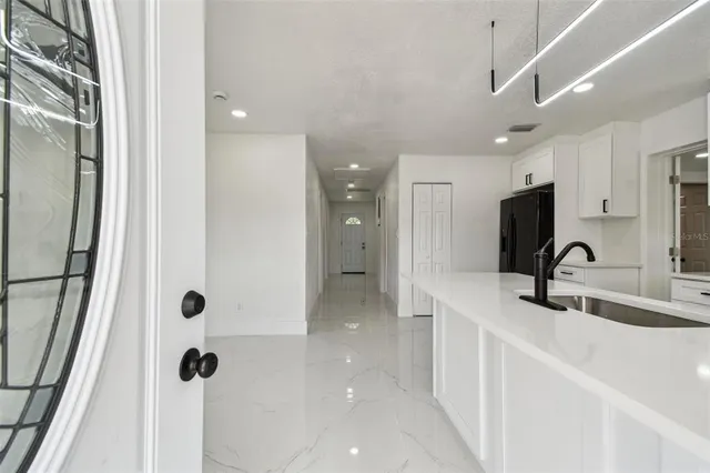 a view of a big room with wooden floor and windows