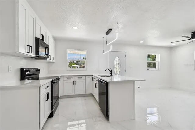 a kitchen with stainless steel appliances a refrigerator stove and sink