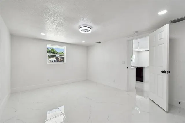 a view of room with window and ceiling fan