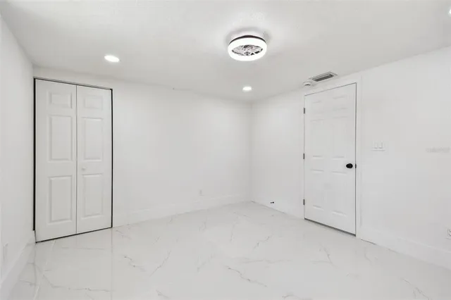 an aerial view of residential houses with outdoor space and trees
