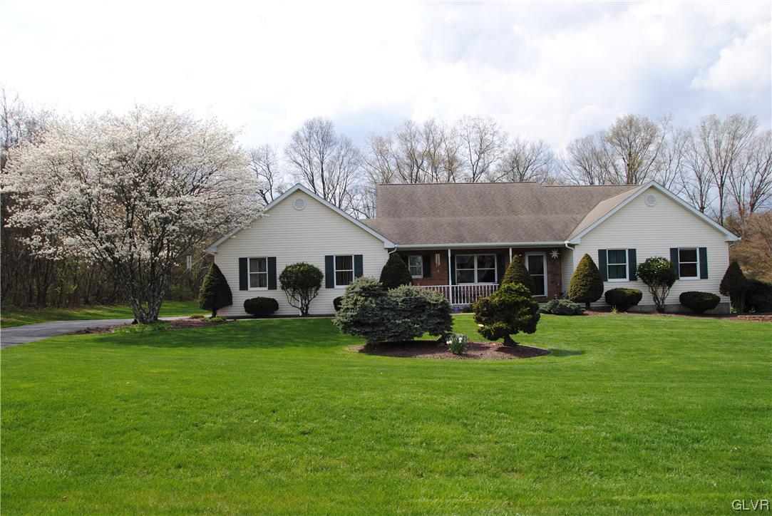 1163 Marfield Drive Nazareth, PA 18064 - Photo 1 of 46 a front view of a house with a garden and trees