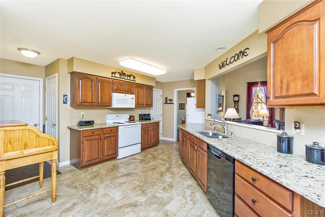 1163 Marfield Drive Nazareth, PA 18064 - Photo 22 of 46 a large kitchen with stainless steel appliances granite countertop a stove and a sink