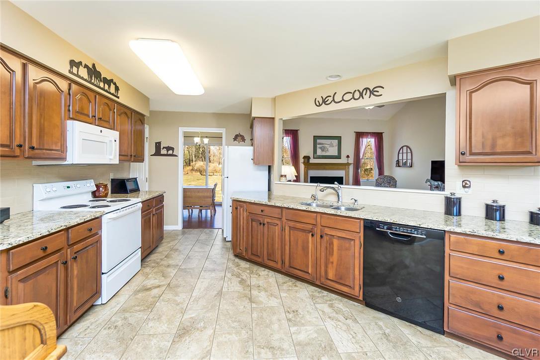 1163 Marfield Drive Nazareth, PA 18064 - Photo 23 of 46 a large kitchen with stainless steel appliances granite countertop a stove and cabinets