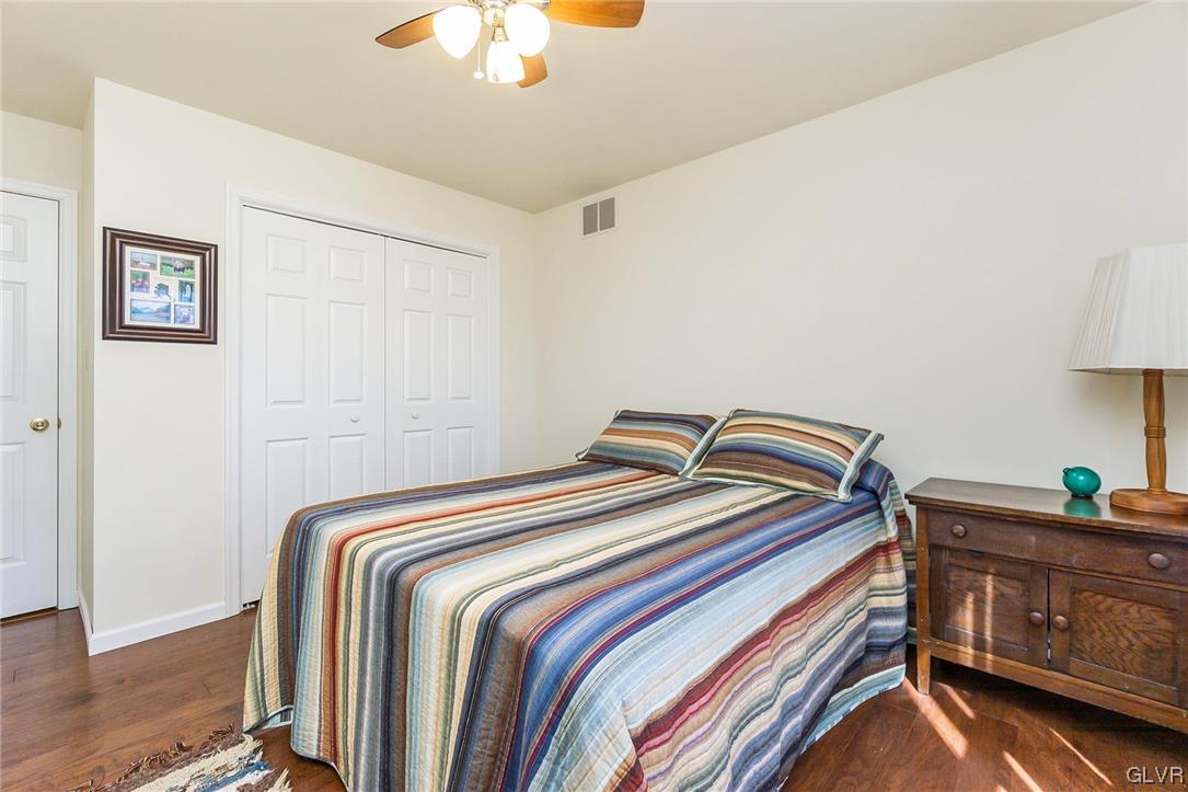 1163 Marfield Drive Nazareth, PA 18064 - Photo 32 of 46 a bedroom with a bed and a chandelier