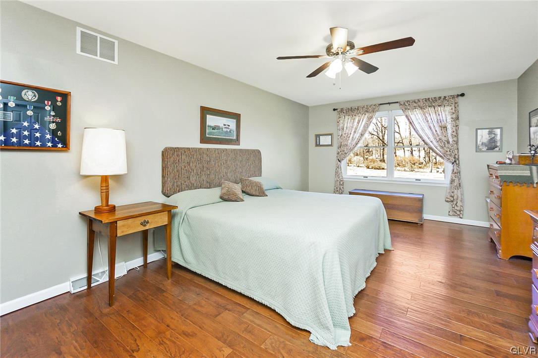 1163 Marfield Drive Nazareth, PA 18064 - Photo 37 of 46 a bedroom with a large bed and a chandelier