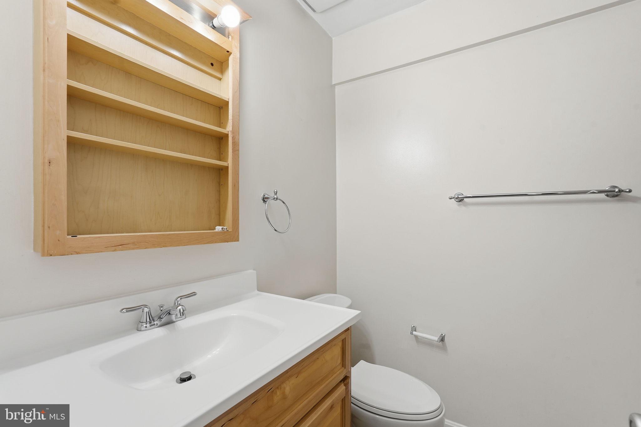 6230 Edsall Road, Unit 403 Alexandria, VA 22312 - Photo 14 of 18 a bathroom with a sink toilet and vanity