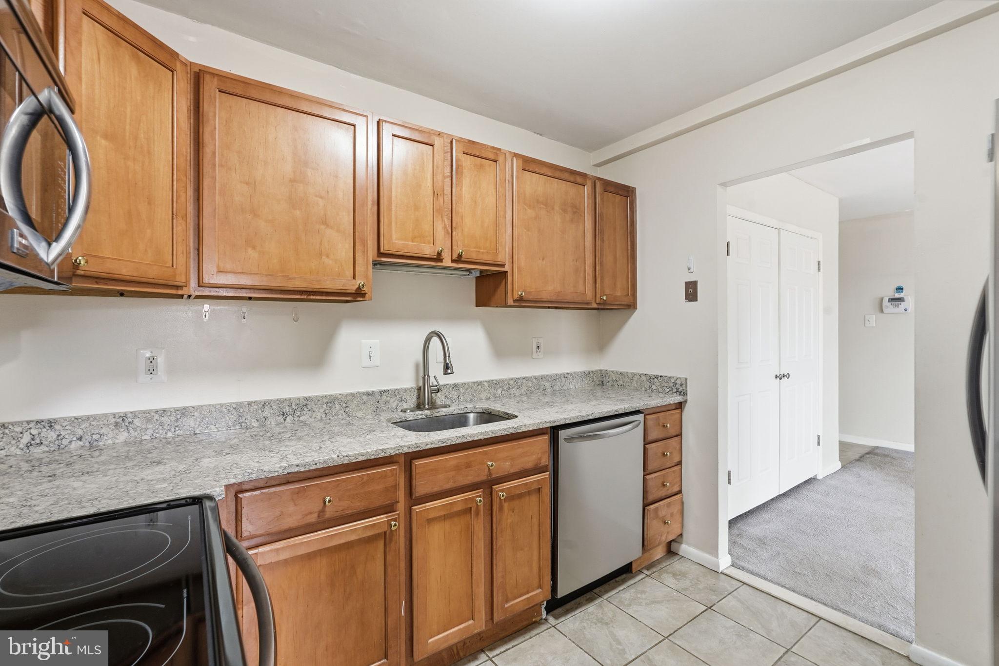 6230 Edsall Road, Unit 403 Alexandria, VA 22312 - Photo 2 of 18 a kitchen with stainless steel appliances granite countertop a sink stove and cabinets