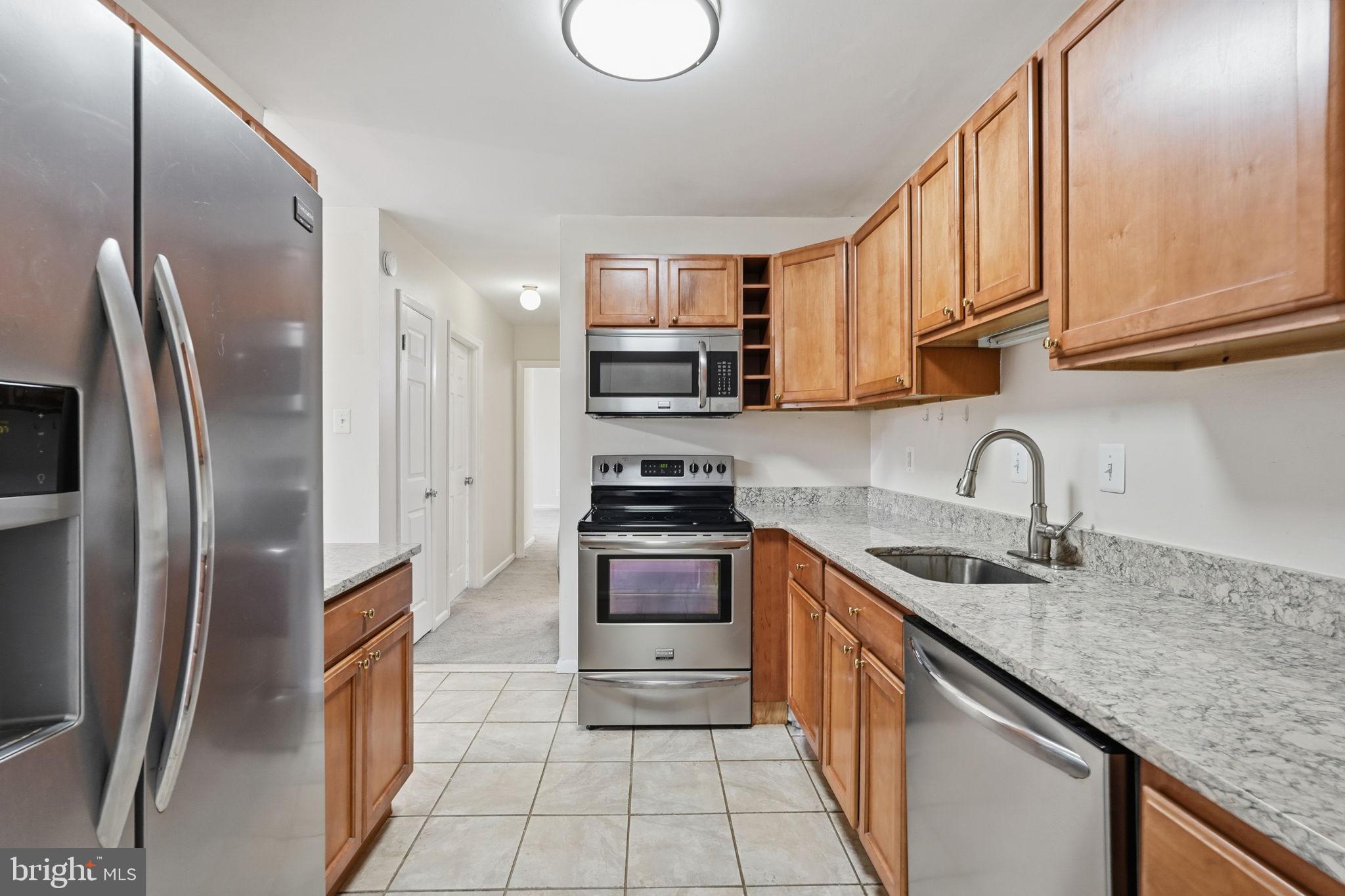6230 Edsall Road, Unit 403 Alexandria, VA 22312 - Photo 3 of 18 a kitchen with stainless steel appliances granite countertop a sink stove and refrigerator