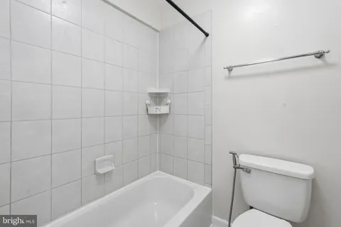 a bathroom with a toilet and bathtub