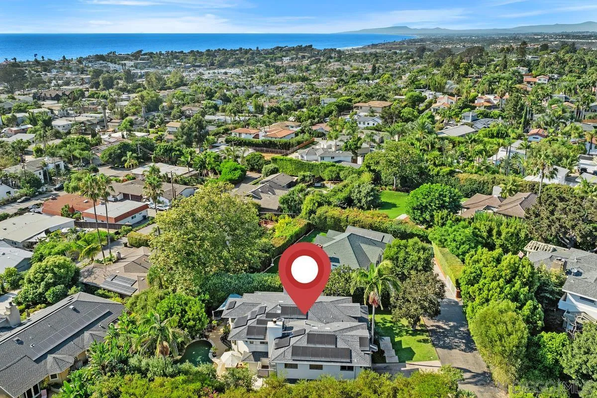 390 East Glaucus Street Encinitas, CA 92024 - Photo 3 of 25 a view of a lush green field with a building in the background