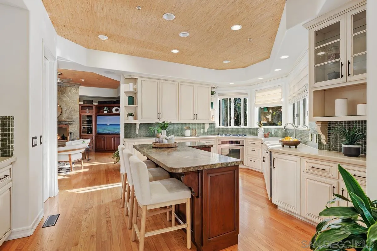 390 East Glaucus Street Encinitas, CA 92024 - Photo 6 of 25 a large kitchen with a table and chairs in it