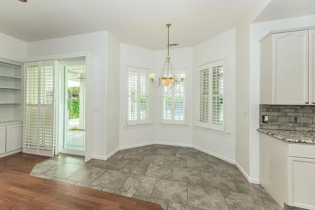 a bathroom with a granite countertop sink mirror bathtub and shower