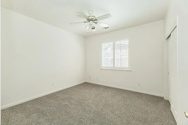 a view of a porch with a table and chairs