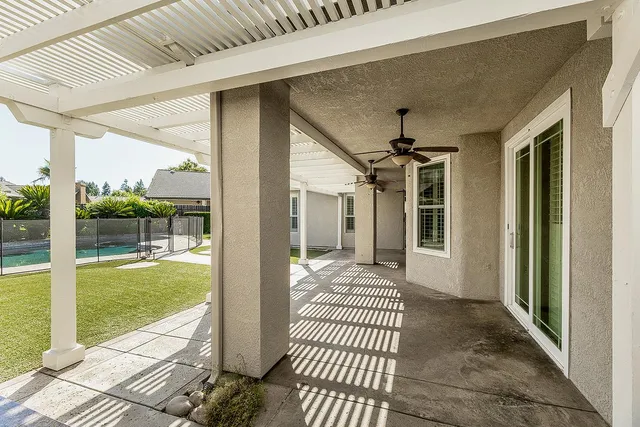 a front view of a house with a garden and plants