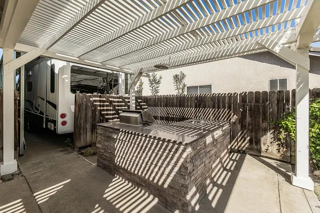 an aerial view of a house with garden space and parking