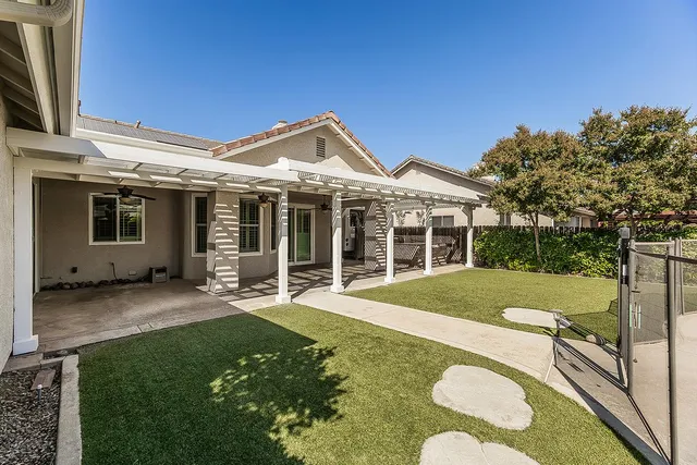 an aerial view of a house with a yard and parking space