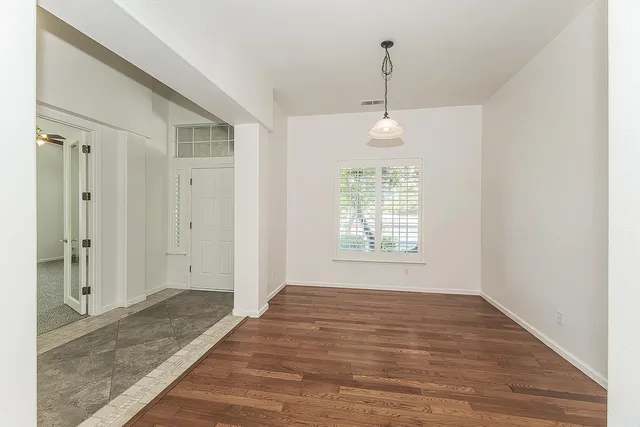 a view of a livingroom with a hardwood floor and a ceiling fan