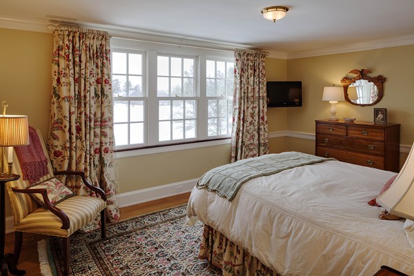 55 Estabrook Road Concord, MA 01742 - Photo 14 of 18 a bedroom with a bed and dresser with mirror