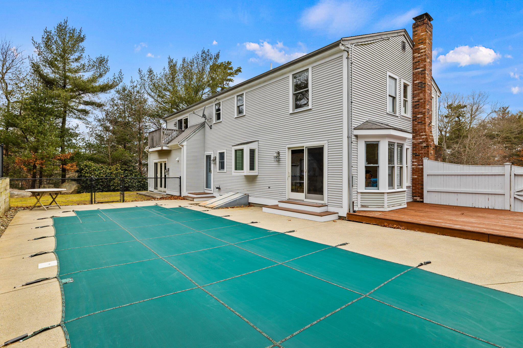 a view of a house with pool and sitting area