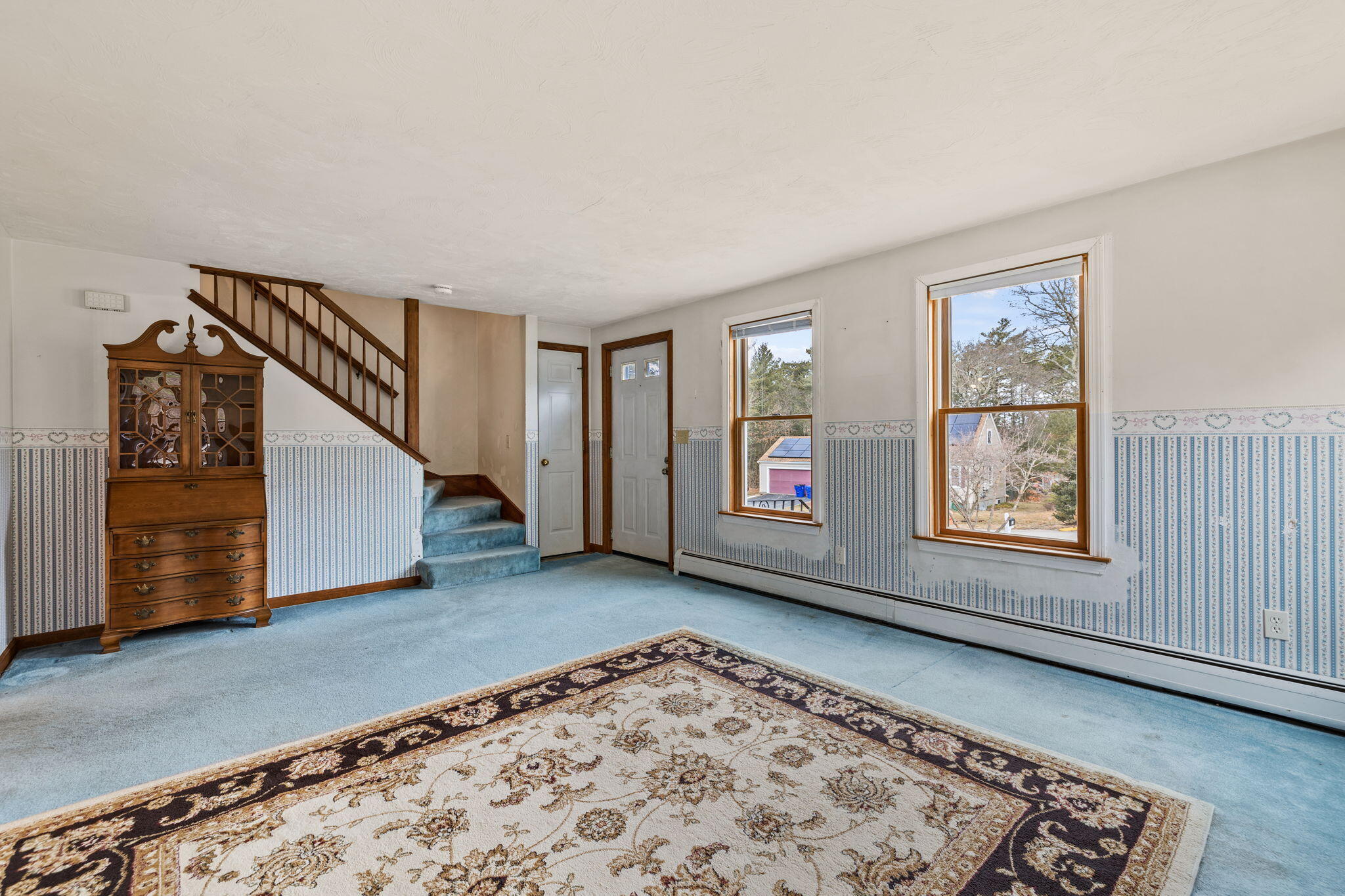 21 Heather Hill Road Buzzards Bay, MA 02532 - Photo 5 of 32 a view of an empty room with window and stairs