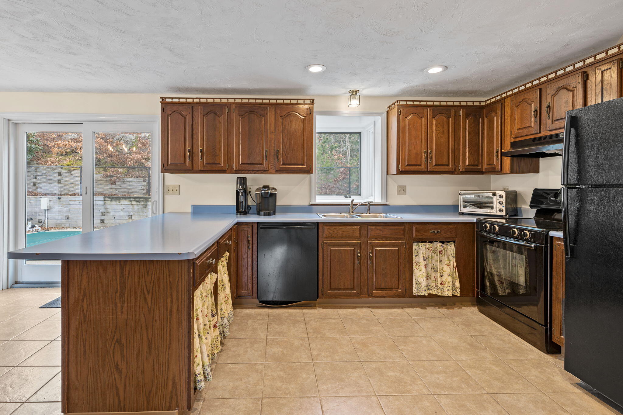21 Heather Hill Road Buzzards Bay, MA 02532 - Photo 8 of 32 a kitchen with stainless steel appliances granite countertop a sink a stove a refrigerator cabinets and a window