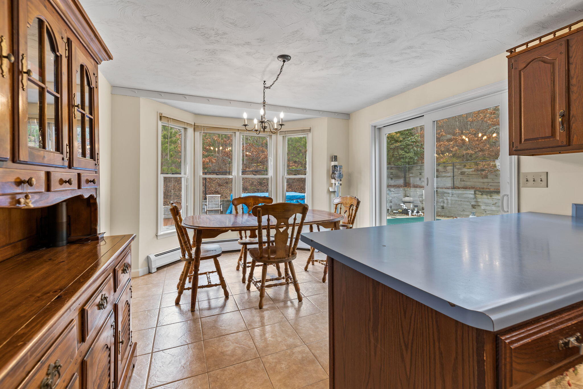 21 Heather Hill Road Buzzards Bay, MA 02532 - Photo 9 of 32 a dining room with furniture a chandelier and wooden floor