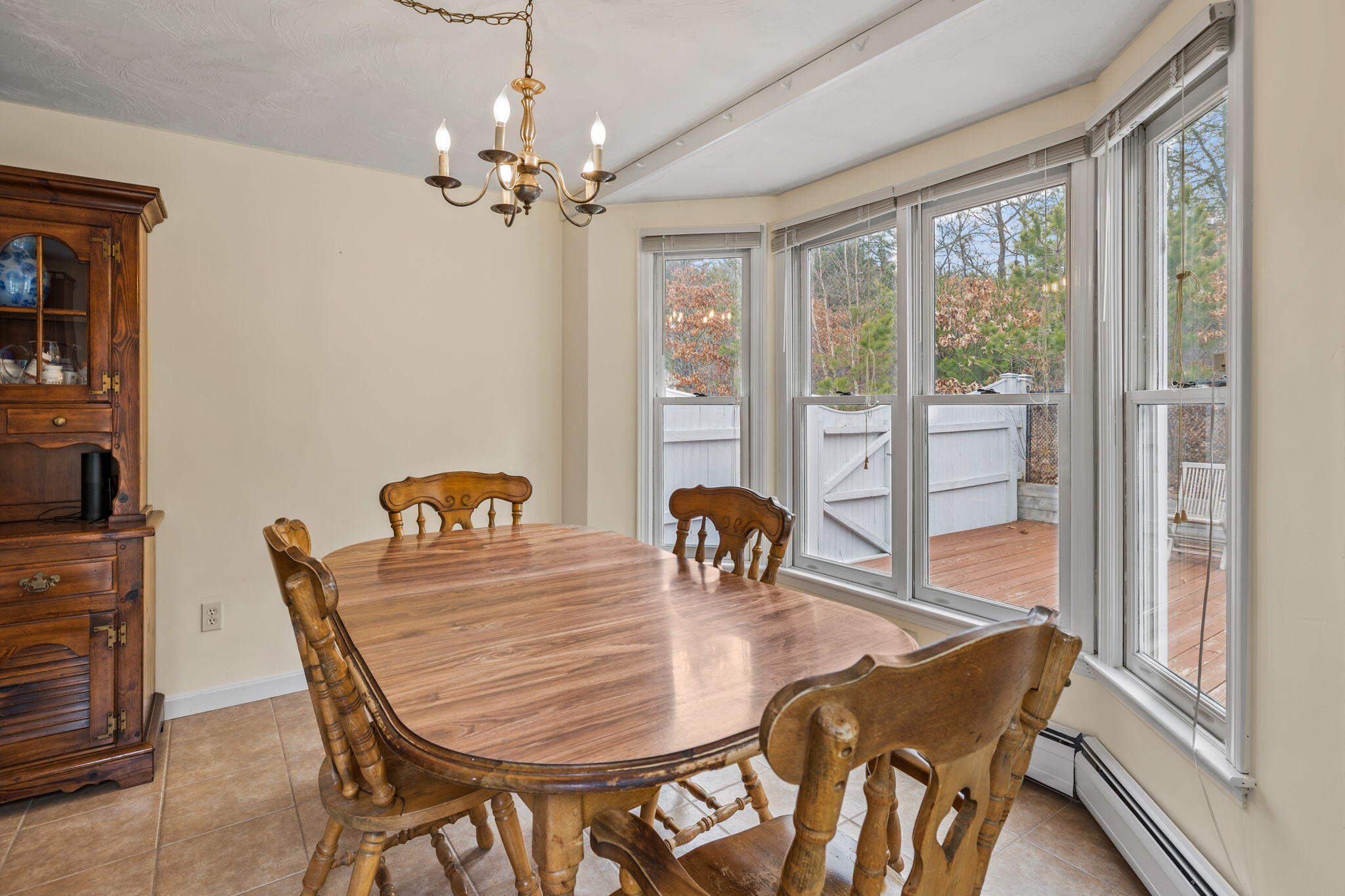 21 Heather Hill Road Buzzards Bay, MA 02532 - Photo 10 of 32 a dining room with furniture a chandelier and wooden floor