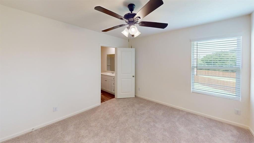 4529 Winecup Road Melissa, TX 75454 - Photo 11 of 29 Spacious bedroom featuring light neutral carpet, a ceiling fan with integrated lighting, and a window with horizontal blinds