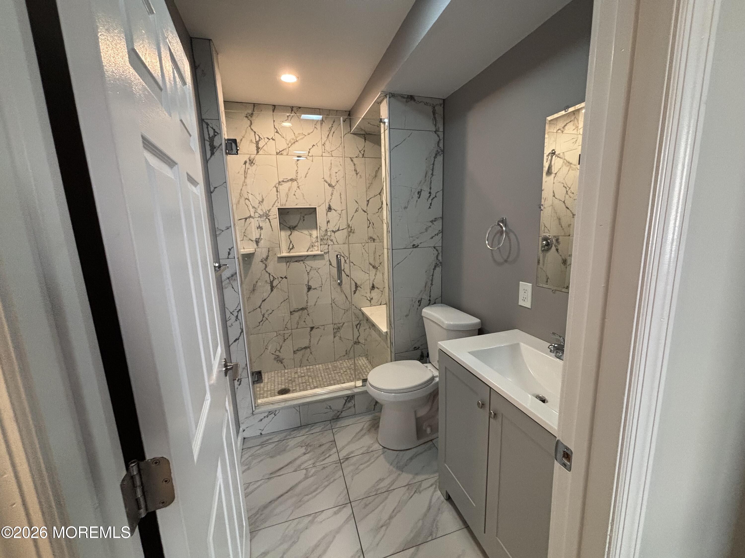 100 Market Yard, Unit 1 Freehold, NJ 07728 - Photo 12 of 12 a bathroom with a granite countertop toilet sink and shower