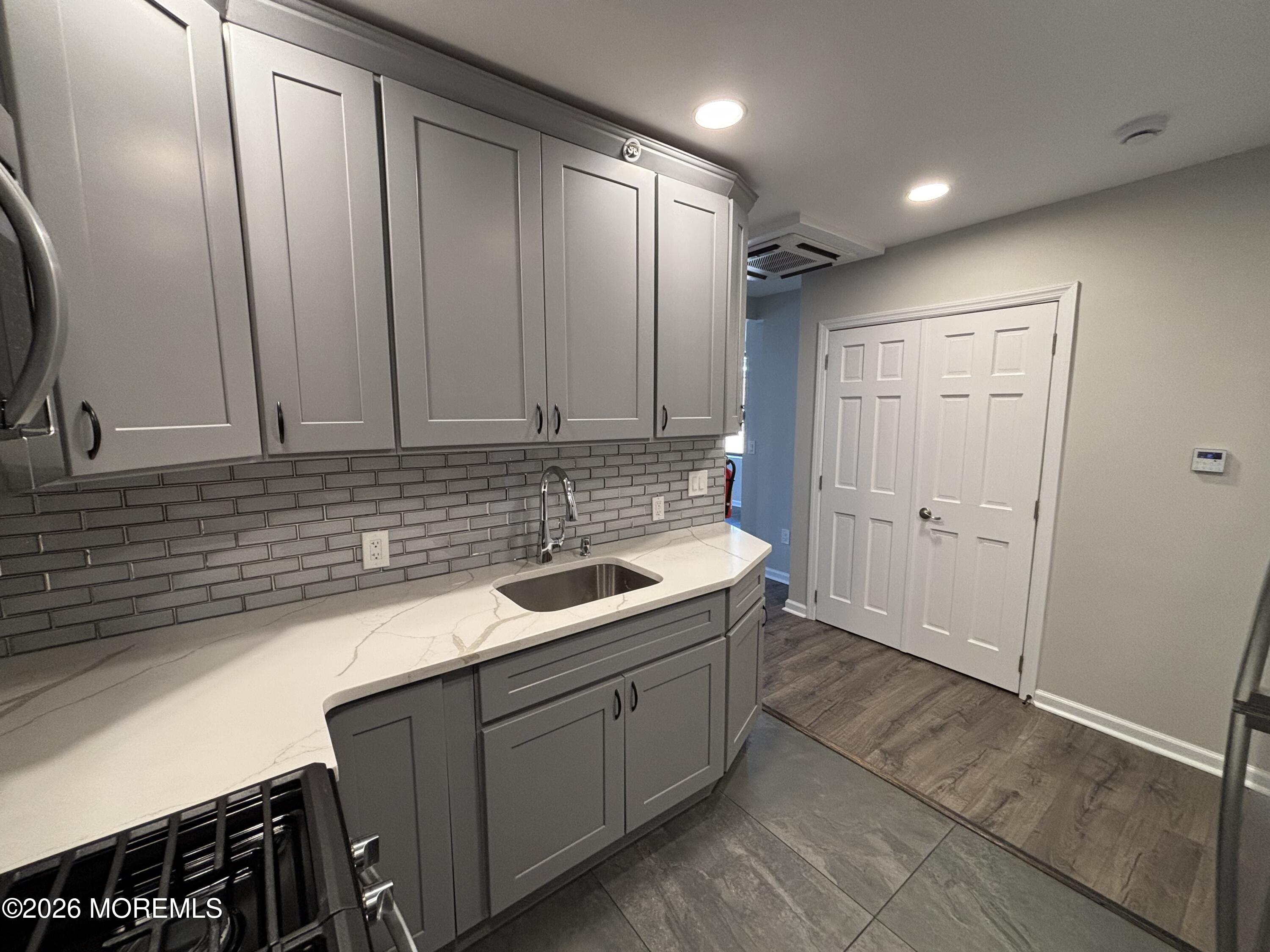 100 Market Yard, Unit 1 Freehold, NJ 07728 - Photo 2 of 12 a bathroom with a sink and a mirror