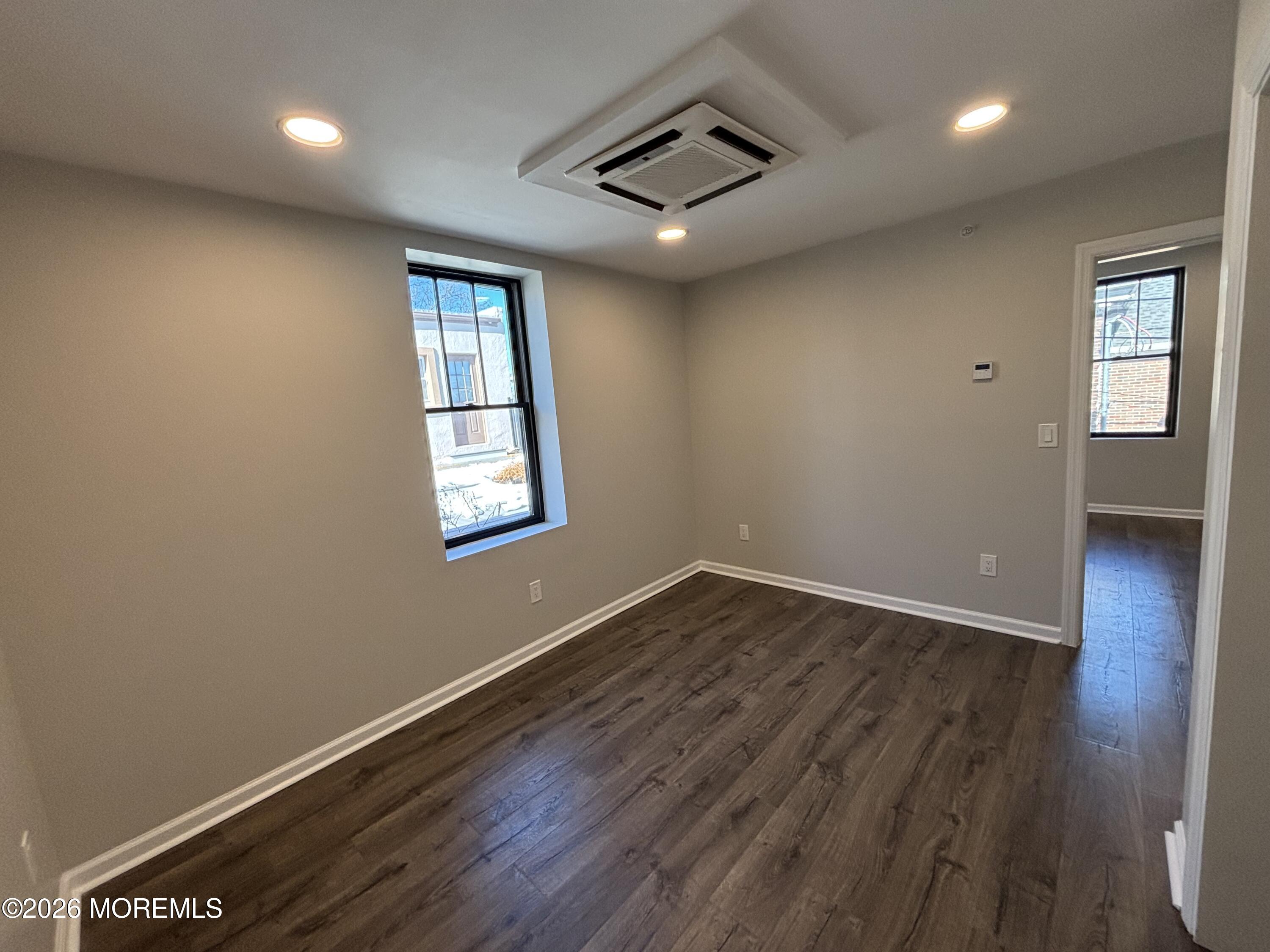 100 Market Yard, Unit 1 Freehold, NJ 07728 - Photo 10 of 12 an empty room with wooden floor and windows