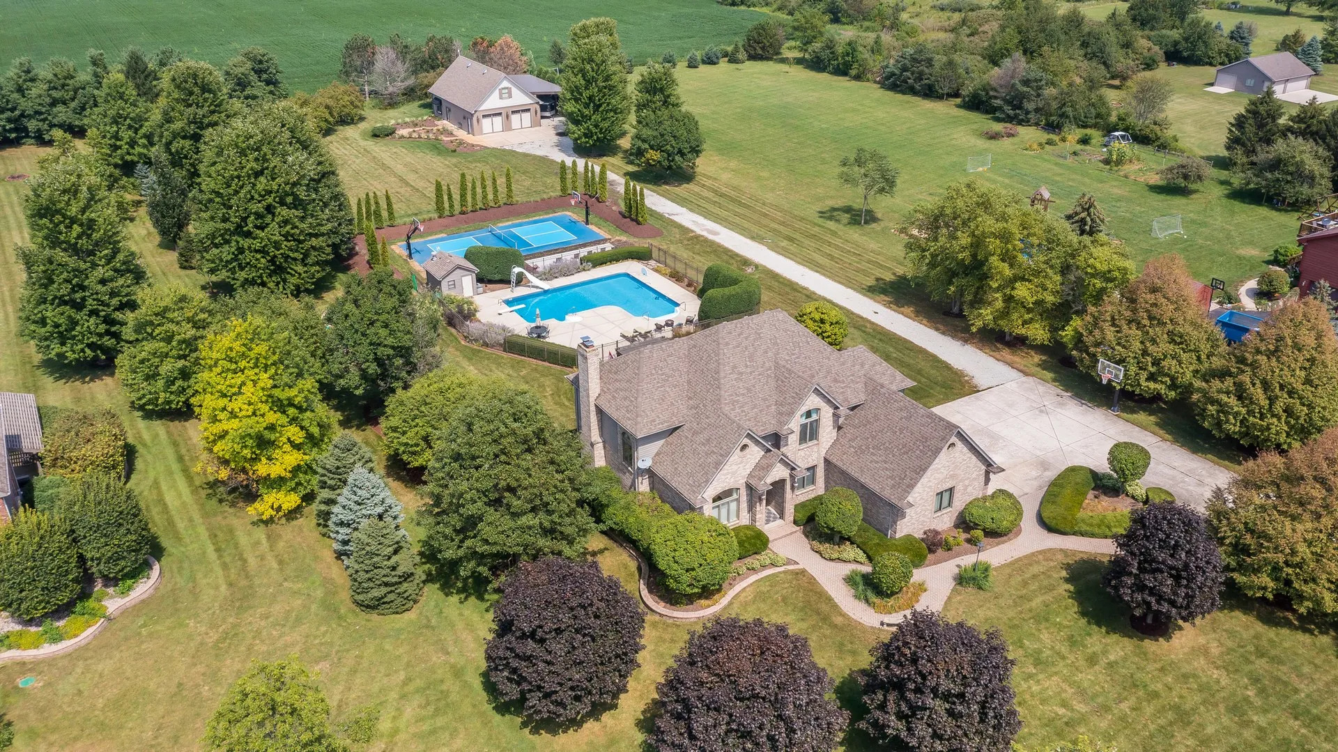 an aerial view of a house a garden and swimming pool