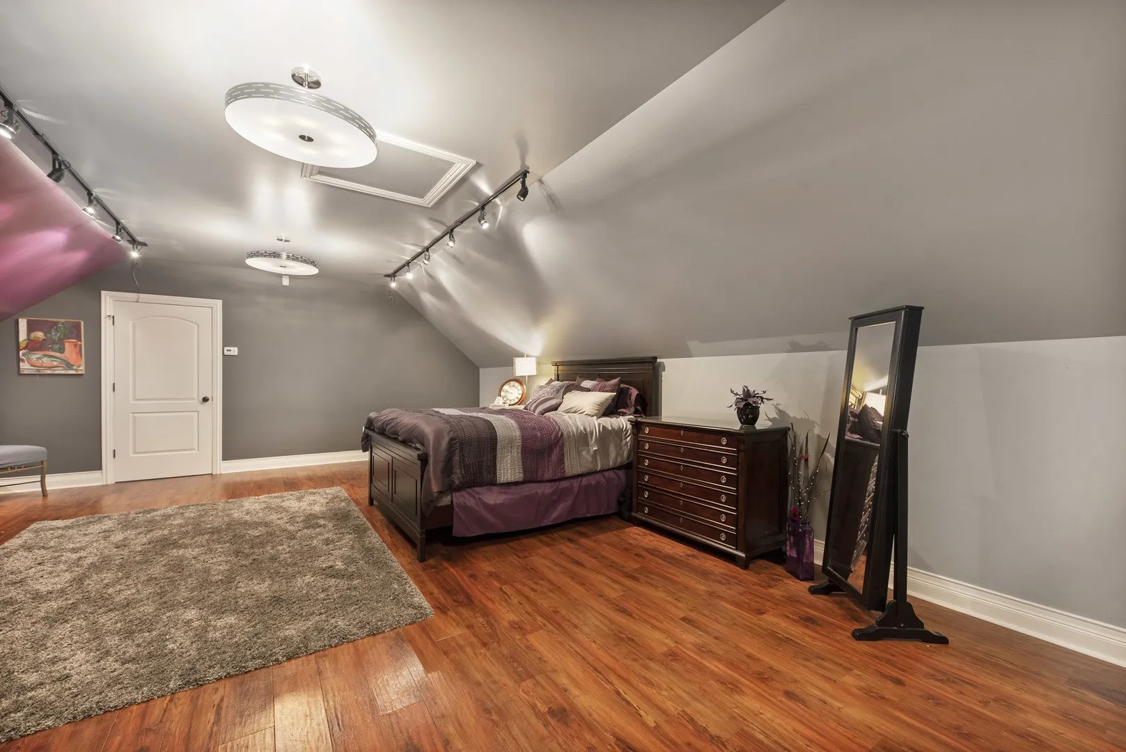 Undisclosed Address Manhattan, IL 60442 - Photo 6 of 9 a spacious bedroom with a bed and a chandelier