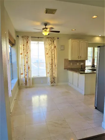 a view of a kitchen with a sink and cabinets